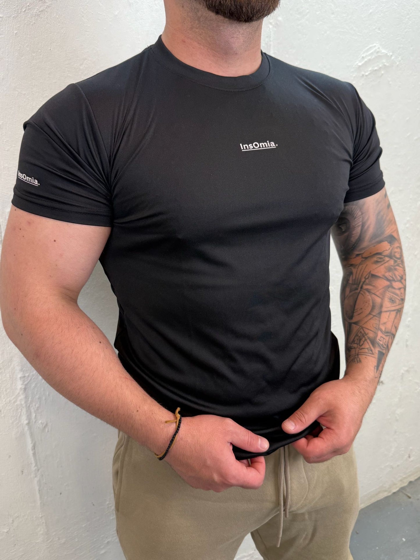 InsOmia.™ Performance Tee – Unisex . Color Black