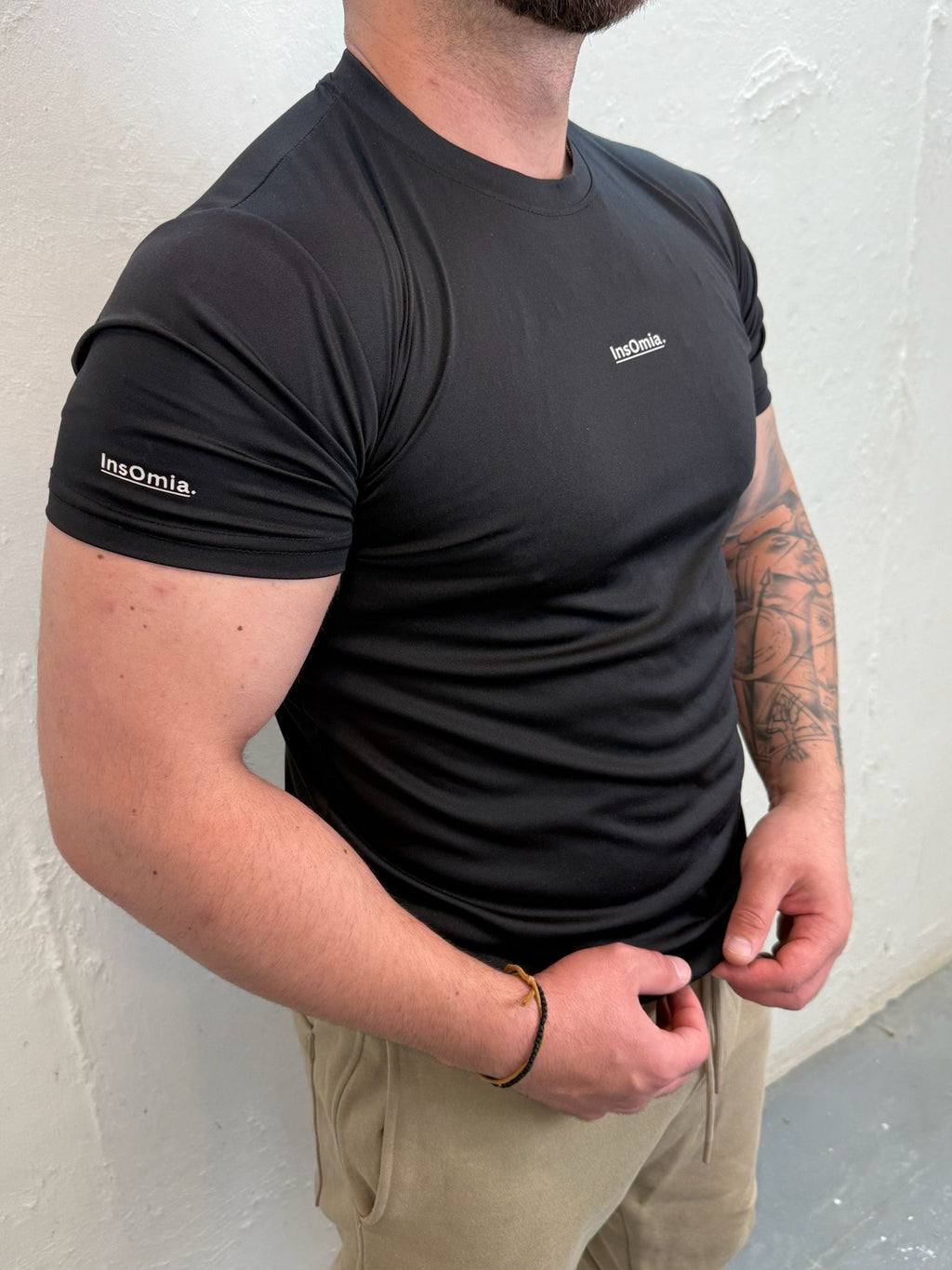 InsOmia.™ Performance Tee – Unisex . Color Black