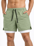 Green shorts with a white label on a plain background